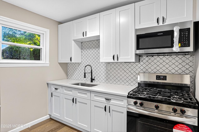 179A Buckelew Ave Unit A, Jamesburg, NJ 08831 - kitchen with stainless steel appliances, light countertops, and white cabinetry