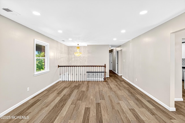 179A Buckelew Ave Unit A, Jamesburg, NJ 08831 - empty room with wood finished floors, recessed lighting, and a chandelier