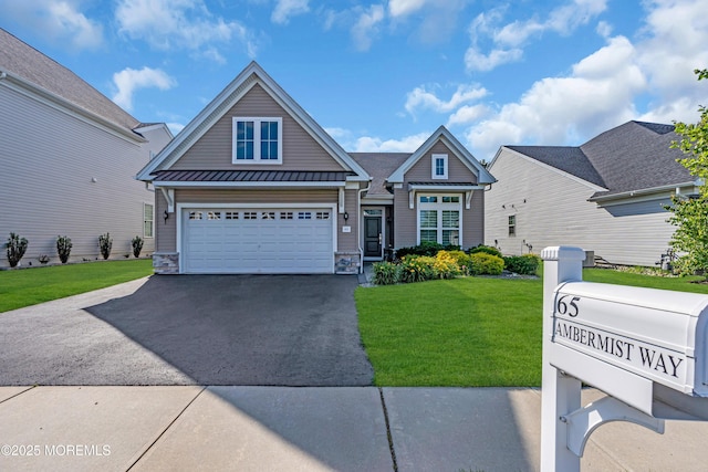 65 Ambermist Way, Forked River, NJ 08731 - view of front of property with driveway, a front lawn, stone siding, a standing seam roof, and a metal roof