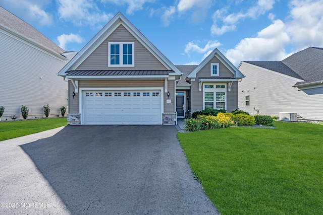 65 Ambermist Way, Forked River, NJ 08731 - view of front of house featuring driveway, a front lawn, a standing seam roof, stone siding, and a metal roof