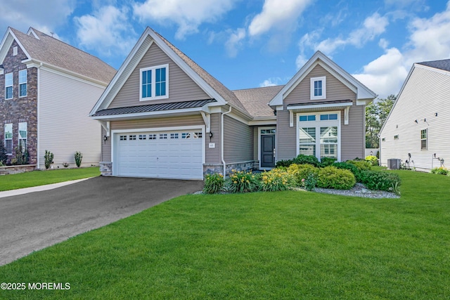 65 Ambermist Way, Forked River, NJ 08731 - view of front of house with driveway, a standing seam roof, a garage, a front yard, and a metal roof