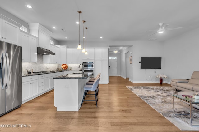 65 Ambermist Way, Forked River, NJ 08731 - kitchen with appliances with stainless steel finishes, open floor plan, under cabinet range hood, ceiling fan, and decorative backsplash