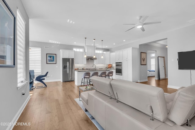 65 Ambermist Way, Forked River, NJ 08731 - living room with healthy amount of natural light, a ceiling fan, recessed lighting, and light wood-style flooring