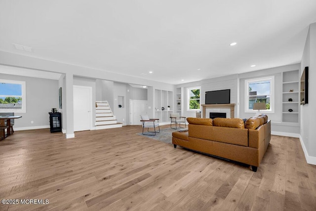 45 Shore Acres Ave, North Middletown, NJ 07748 - living room featuring light wood finished floors, built in features, a fireplace, healthy amount of natural light, and recessed lighting