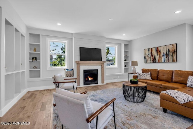 45 Shore Acres Ave, North Middletown, NJ 07748 - living area featuring built in shelves, light wood-style flooring, a fireplace, and recessed lighting