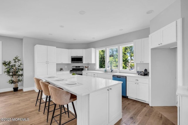 45 Shore Acres Ave, North Middletown, NJ 07748 - kitchen with appliances with stainless steel finishes, light wood-type flooring, and white cabinetry