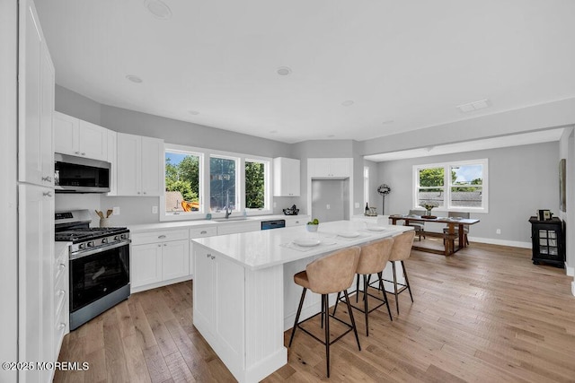 45 Shore Acres Ave, North Middletown, NJ 07748 - kitchen with appliances with stainless steel finishes, light wood-style flooring, and white cabinetry