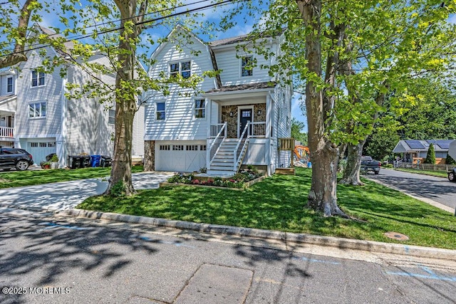 45 Shore Acres Ave, North Middletown, NJ 07748 - view of front facade with concrete driveway, a front yard, stairway, and an attached garage