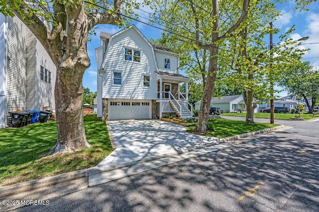 45 Shore Acres Ave, North Middletown, NJ 07748 - view of front of property featuring a gambrel roof, concrete driveway, stairway, an attached garage, and a front lawn