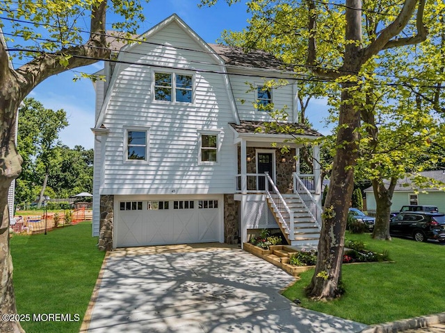 45 Shore Acres Ave, North Middletown, NJ 07748 - view of front of house with stone siding, concrete driveway, and an attached garage