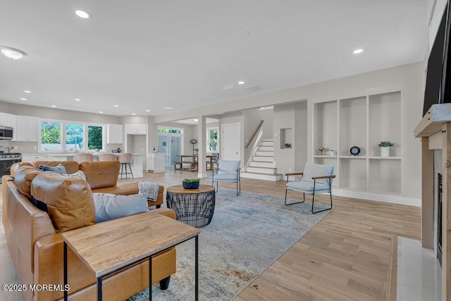 45 Shore Acres Ave, North Middletown, NJ 07748 - living room with built in features, light wood-style flooring, recessed lighting, a high end fireplace, and stairway