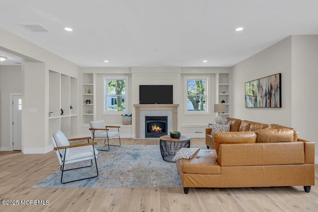 45 Shore Acres Ave, North Middletown, NJ 07748 - living room with built in features, a fireplace, light wood finished floors, and recessed lighting