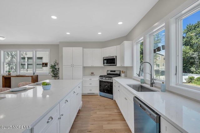 45 Shore Acres Ave, North Middletown, NJ 07748 - kitchen with stainless steel appliances, healthy amount of natural light, light wood-style flooring, recessed lighting, and white cabinetry