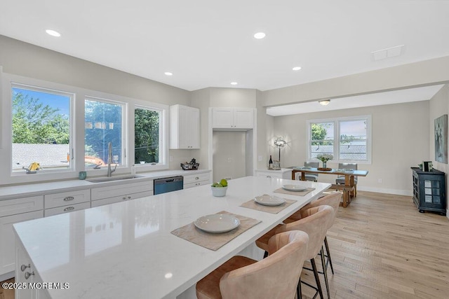 45 Shore Acres Ave, North Middletown, NJ 07748 - kitchen featuring dishwasher, a breakfast bar area, white cabinetry, light wood-style flooring, and recessed lighting