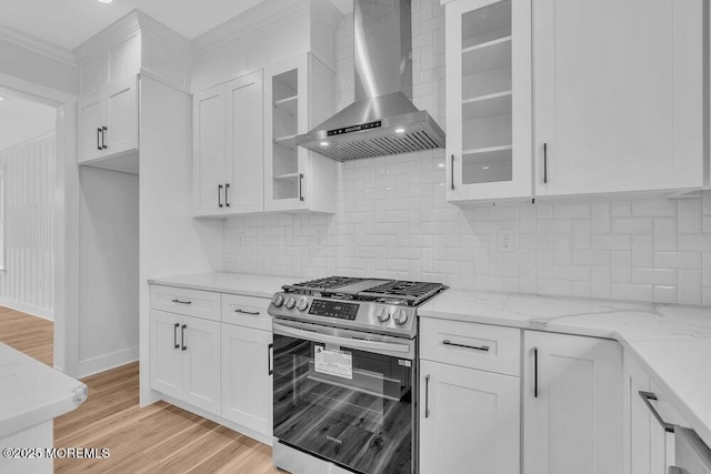 12 Outsail Ave, Barnegat, NJ 08005 - kitchen with wall chimney range hood, gas stove, white cabinetry, and ornamental molding