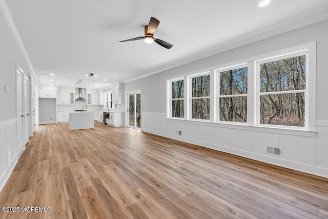 12 Outsail Ave, Barnegat, NJ 08005 - unfurnished living room featuring crown molding, a decorative wall, ceiling fan, light wood-style flooring, and recessed lighting
