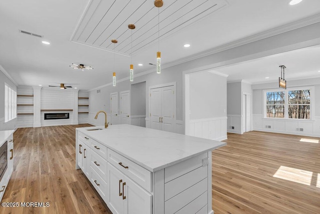 12 Outsail Ave, Barnegat, NJ 08005 - kitchen featuring open floor plan, a ceiling fan, decorative light fixtures, light wood-style floors, and wainscoting
