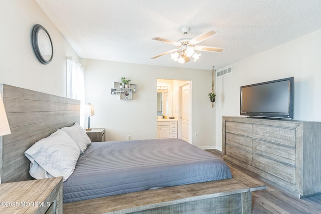 887 Beach Haven W Blvd, Manahawkin, NJ 08050 - bedroom featuring wood finished floors, a textured ceiling, ceiling fan, and connected bathroom