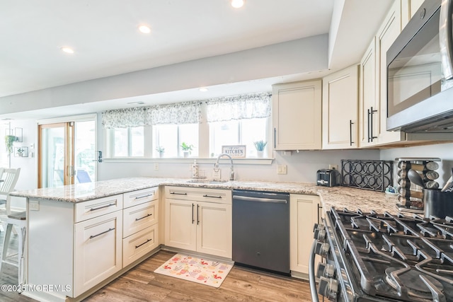 887 Beach Haven W Blvd, Manahawkin, NJ 08050 - kitchen with appliances with stainless steel finishes, light wood finished floors, a peninsula, recessed lighting, and light stone countertops