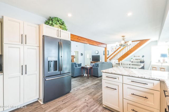 887 Beach Haven W Blvd, Manahawkin, NJ 08050 - kitchen with stainless steel fridge, a chandelier, light wood-style flooring, beam ceiling, and light stone countertops