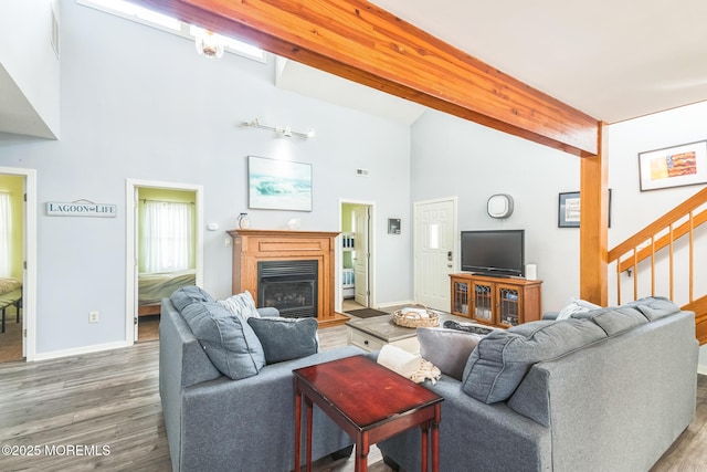 887 Beach Haven W Blvd, Manahawkin, NJ 08050 - living room featuring wood finished floors, stairway, beam ceiling, high vaulted ceiling, and a glass covered fireplace