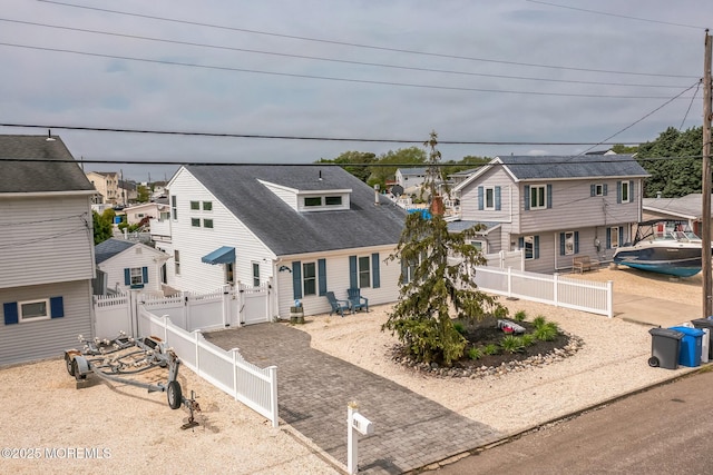 887 Beach Haven W Blvd, Manahawkin, NJ 08050 - view of front of home featuring a residential view, a fenced backyard, and a shingled roof
