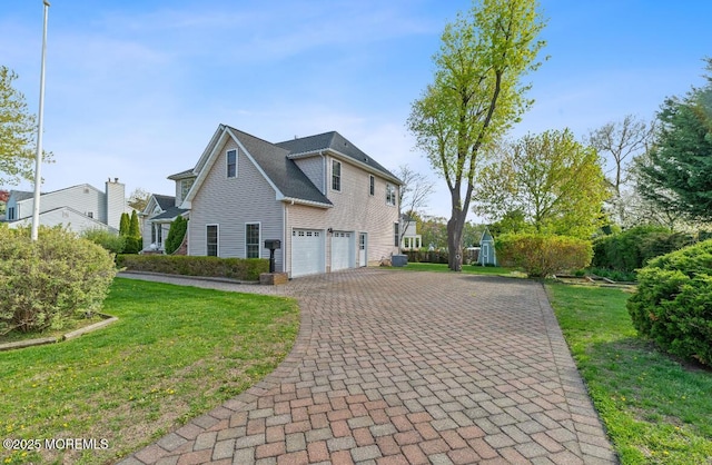 408 Brookdale Ave, Long Branch, NJ 07740 - view of property exterior featuring a garage, driveway, and a lawn