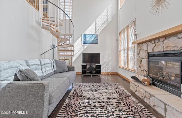 408 Brookdale Ave, Long Branch, NJ 07740 - living area with a high ceiling, stairway, a stone fireplace, and wood finished floors
