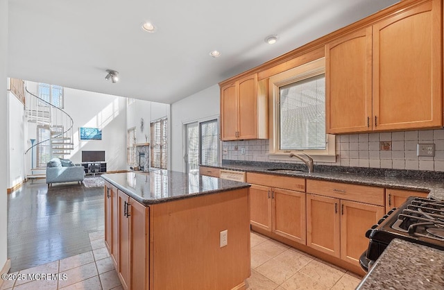 408 Brookdale Ave, Long Branch, NJ 07740 - kitchen with a center island, decorative backsplash, gas stove, dark stone countertops, and recessed lighting