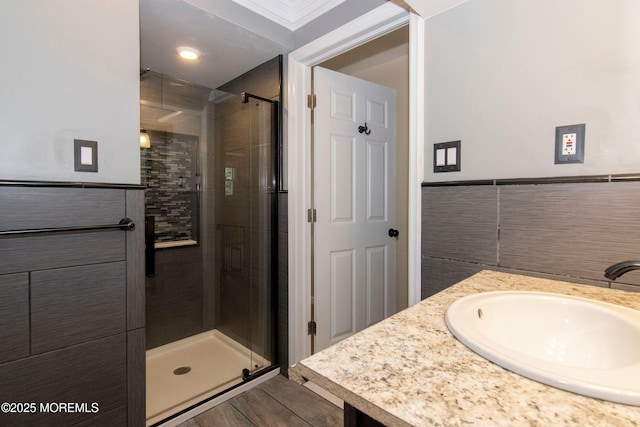 67 School Rd E, Marlboro, NJ 07746 - full bath with a stall shower, vanity, wood finished floors, and tile walls