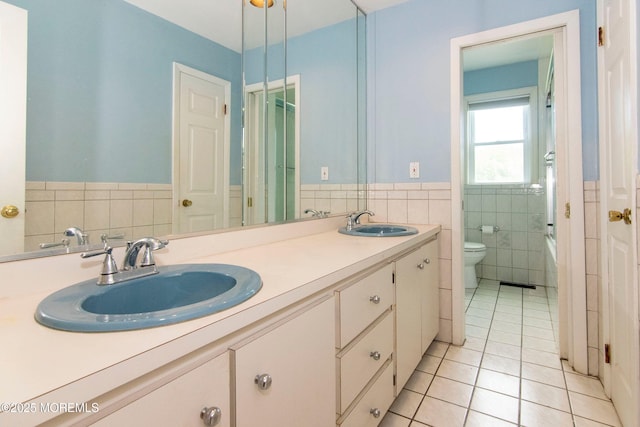 67 School Rd E, Marlboro, NJ 07746 - full bathroom with tile walls, tile patterned flooring, double vanity, and wainscoting
