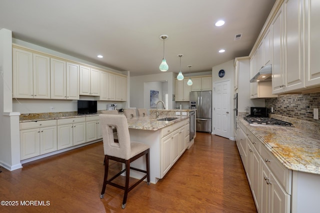 5 Gainsborough Ln, Manchester, NJ 08759 - kitchen with stainless steel appliances, wood finished floors, a breakfast bar area, recessed lighting, and an island with sink