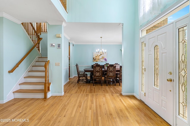 3 Knightsbridge Pl, Jackson, NJ 08527 - entryway featuring stairway, light wood-style flooring, a towering ceiling, a chandelier, and crown molding