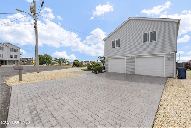 28 S Dayton Dr, Little Egg Harbor, NJ 08087 - view of side of home with decorative driveway and an attached garage