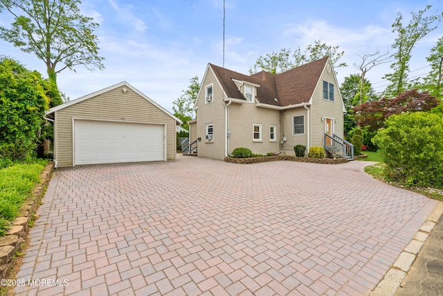 334 Norgrove Pl, Elberon, NJ 07740 - view of front of house featuring an outdoor structure, a detached garage, and stucco siding