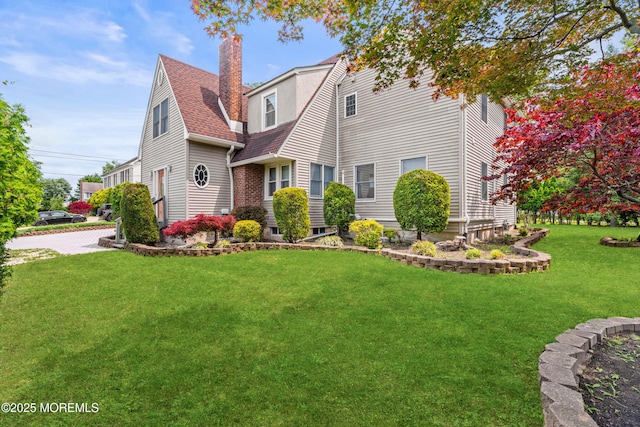 334 Norgrove Pl, Elberon, NJ 07740 - view of front of house with a front yard, a chimney, and a shingled roof