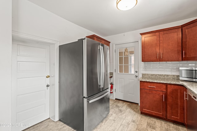 334 Norgrove Pl, Elberon, NJ 07740 - kitchen with stainless steel appliances, light stone counters, light wood-style flooring, and decorative backsplash