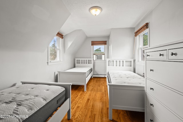 334 Norgrove Pl, Elberon, NJ 07740 - bedroom featuring multiple windows, cooling unit, light wood-style floors, and a baseboard heating unit