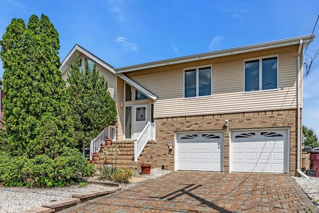 259 Cypress Dr, Bayville, NJ 08721 - view of front of home featuring brick siding, an attached garage, and decorative driveway