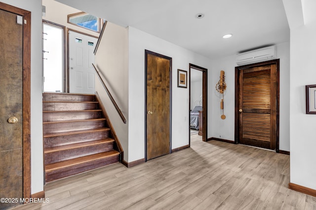 259 Cypress Dr, Bayville, NJ 08721 - foyer entrance with a wall unit AC, light wood finished floors, stairs, and recessed lighting
