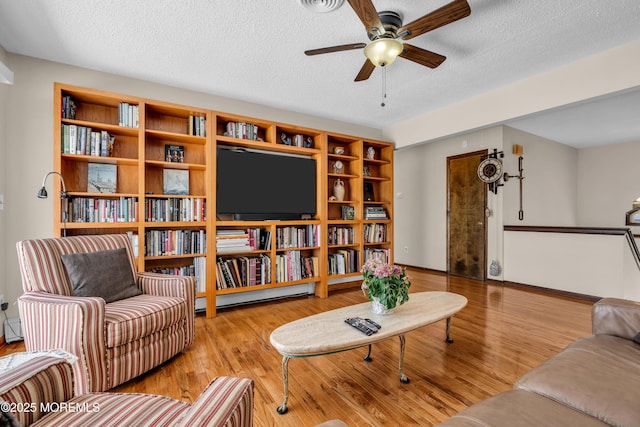 259 Cypress Dr, Bayville, NJ 08721 - living area with wood finished floors, a ceiling fan, and a textured ceiling