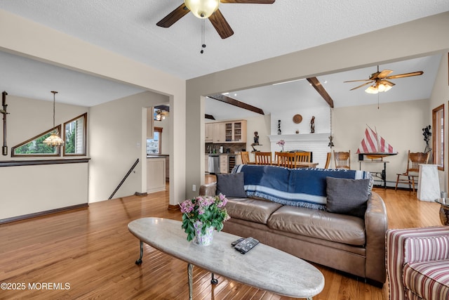 259 Cypress Dr, Bayville, NJ 08721 - living room featuring ceiling fan, a baseboard radiator, light wood finished floors, and beamed ceiling