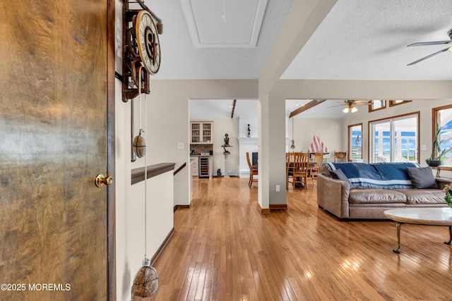 259 Cypress Dr, Bayville, NJ 08721 - living room featuring ceiling fan, light wood-style flooring, attic access, and wine cooler
