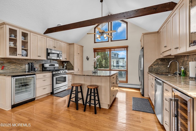 259 Cypress Dr, Bayville, NJ 08721 - kitchen with stainless steel appliances, beverage cooler, a center island, beamed ceiling, and light wood-style floors