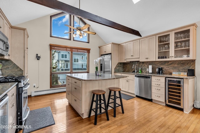 259 Cypress Dr, Bayville, NJ 08721 - kitchen featuring wine cooler, appliances with stainless steel finishes, baseboard heating, decorative backsplash, and a kitchen island