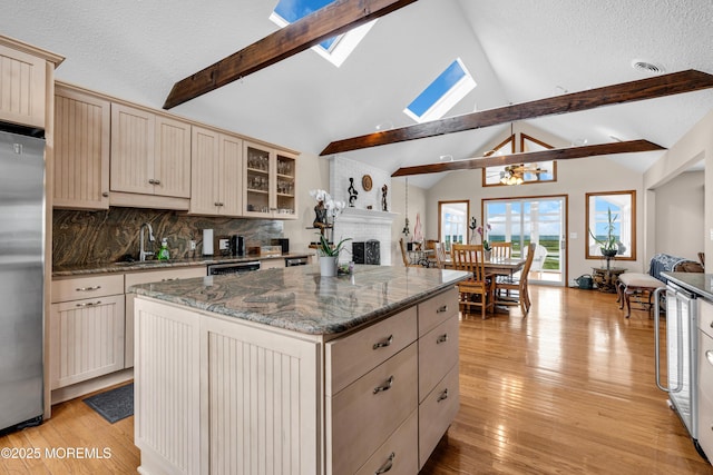 259 Cypress Dr, Bayville, NJ 08721 - kitchen featuring stainless steel appliances, a skylight, a brick fireplace, open floor plan, and a center island