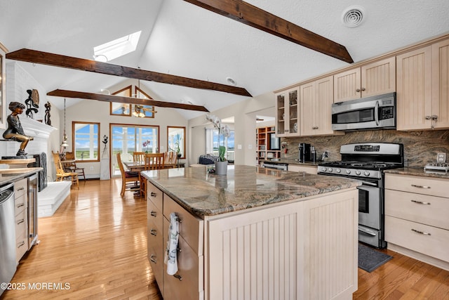259 Cypress Dr, Bayville, NJ 08721 - kitchen featuring stainless steel appliances, light wood-style floors, tasteful backsplash, a kitchen island, and a skylight