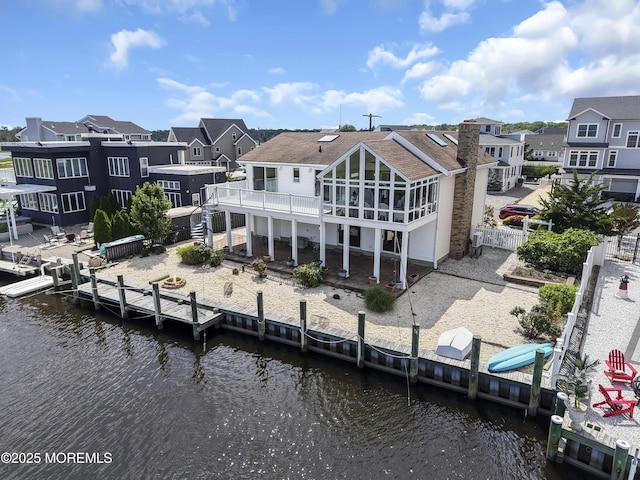 259 Cypress Dr, Bayville, NJ 08721 - rear view of property with a residential view, a deck with water view, a patio area, and a sunroom