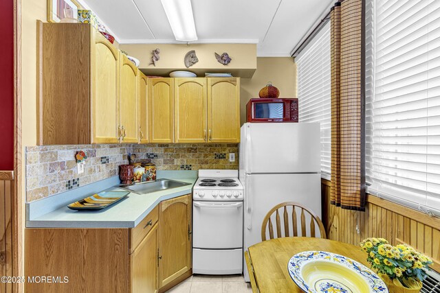 28 Fremont Ave Unit B12, Seaside Heights, NJ 08751 - kitchen with white appliances, light countertops, decorative backsplash, ornamental molding, and light tile patterned floors