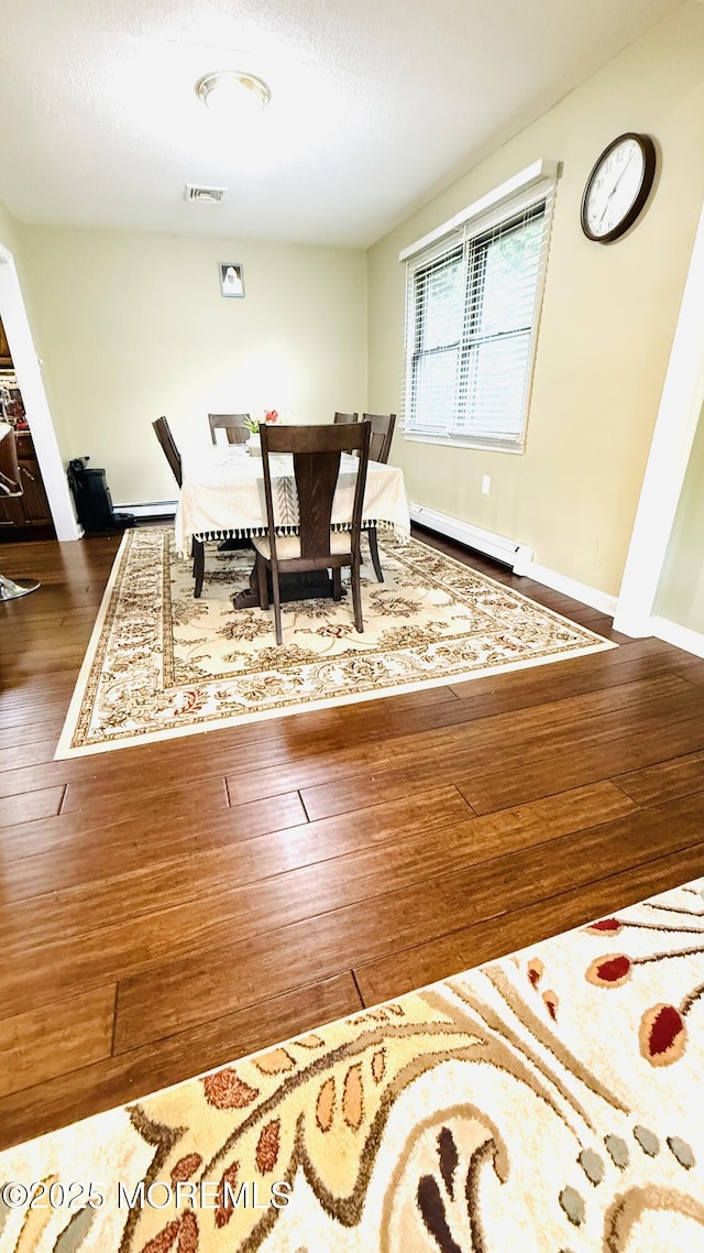 9 Longfellow Ter, Morganville, NJ 07751 - dining area featuring baseboard heating and hardwood / wood-style floors